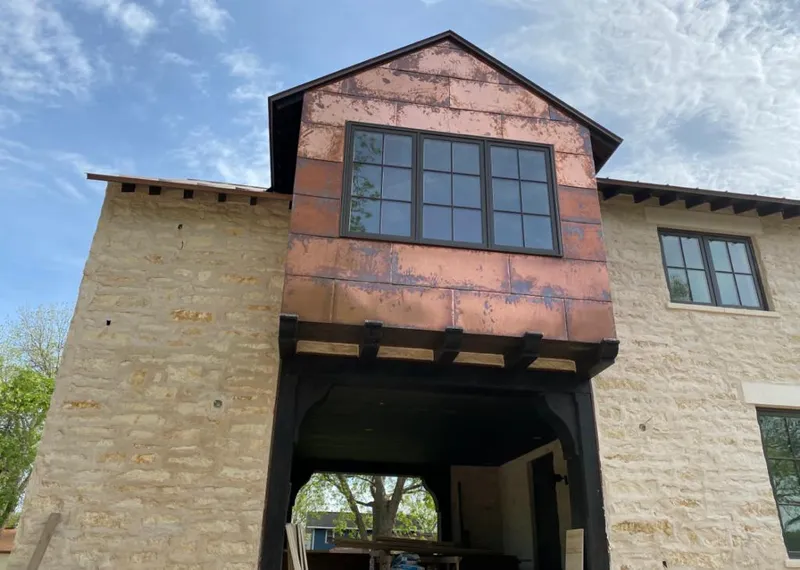 Copper metal panel facade on a stone building for Skylight Installation in Scott